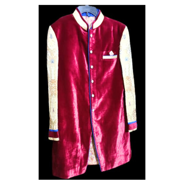 The rich maroon color not only symbolizes opulence but also carries cultural significance, often associated with traditional Indian ceremonies and celebrations. The velvet fabric enhances the overall look, providing a smooth and lustrous texture that complements the festive and celebratory atmosphere.