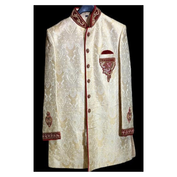 The sherwani features a classic silhouette with detailed embellishments that highlight the rich cultural heritage of India. The golden hue symbolizes prosperity and grandeur, while the maroon embroidery adds a touch of sophistication. The luxurious Banarasi silk fabric drapes gracefully, enhancing the overall royal aura of the attire.