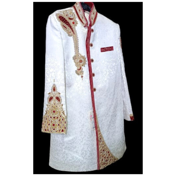 The sherwani features intricate embroidery and embellishments, showcasing a symphony of traditional Indian craftsmanship. The heavy detailing is thoughtfully placed, highlighting the rich cultural heritage while maintaining a modern aesthetic.